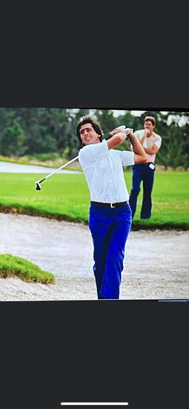 Seve Ballesteros hits out of the bunker on the 18th hole in the 1983 Ryder Cup at PGA National in Palm Beach Gardens - while a pensive Craig Dolch watches from behind.