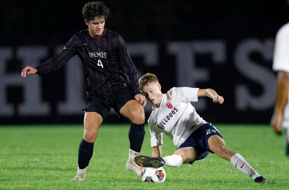 Okemos' Will Swihart, left, and Mason's Lucas Nay battle, Tuesday, Oct. 5, 2021, in Okemos, Mich. Okemos won 5-2.