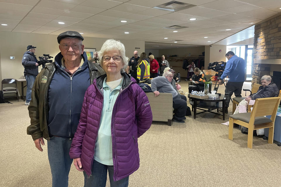 Darwin and Sharon Heida wait at Unity Christian Reformed Church in Prinsburg, Minn., hours after a train derailed near their home in Raymond, Minn., Thursday, March 30, 2023. The train was hauling ethanol and corn syrup and caught fire that morning, prompting officials to order hundreds of residents to evacuate. (AP Photo/Trisha Ahmed)