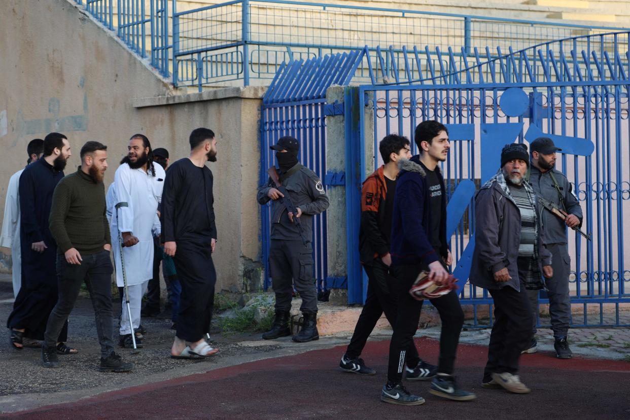 Muslim worshippers enter the secured municipal stadium in Syria’s rebel-held northwestern city of Idlib to attend the morning prayers (MOHAMMED AL-RIFAI/AFP via Getty Images)