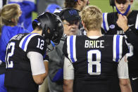 Duke coach David Cutcliffe talks to quarterbacks Chase Brice (8) and Gunnar Holmberg (12) during the second half against Charlotte in an NCAA college football game Saturday, Oct. 31, 2020, in Durham, N.C. (Jaylynn Nash/Pool Photo via AP)