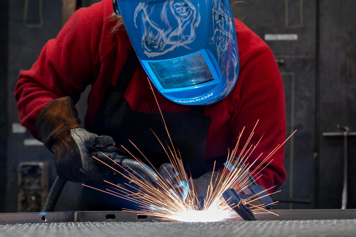 Danielle Roberts welds together a wire screen to a frame during her shift at Wire Crafters on Wednesday, March 20, 2024.