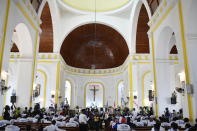 People attend a memorial service for assassinated President Jovenel Moïse in the Cathedral of Cap-Haitien, Haiti, Thursday, July 22, 2021. Moïse was killed in his home on July 7. (AP Photo/Matias Delacroix)