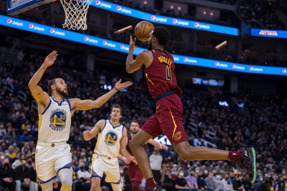 Cleveland Cavaliers center Evan Mobley (4) prepares to shoot as Golden State Warriors guard Stephen Curry (30) defends during the first half of an NBA basketball game in San Francisco, Sunday, Jan. 9, 2022. (AP Photo/John Hefti)