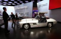 DETROIT, MI - JANUARY 11: Journalists look over a 1954 Mercedes-Benz 300SL during the press preview of the North American International Auto Show at the Cobo Center on January 11, 2011 in Detroit, Michigan. The show is currently opened only for media previews and opens to the general public January 15-23. (Photo by Scott Olson/Getty Images)