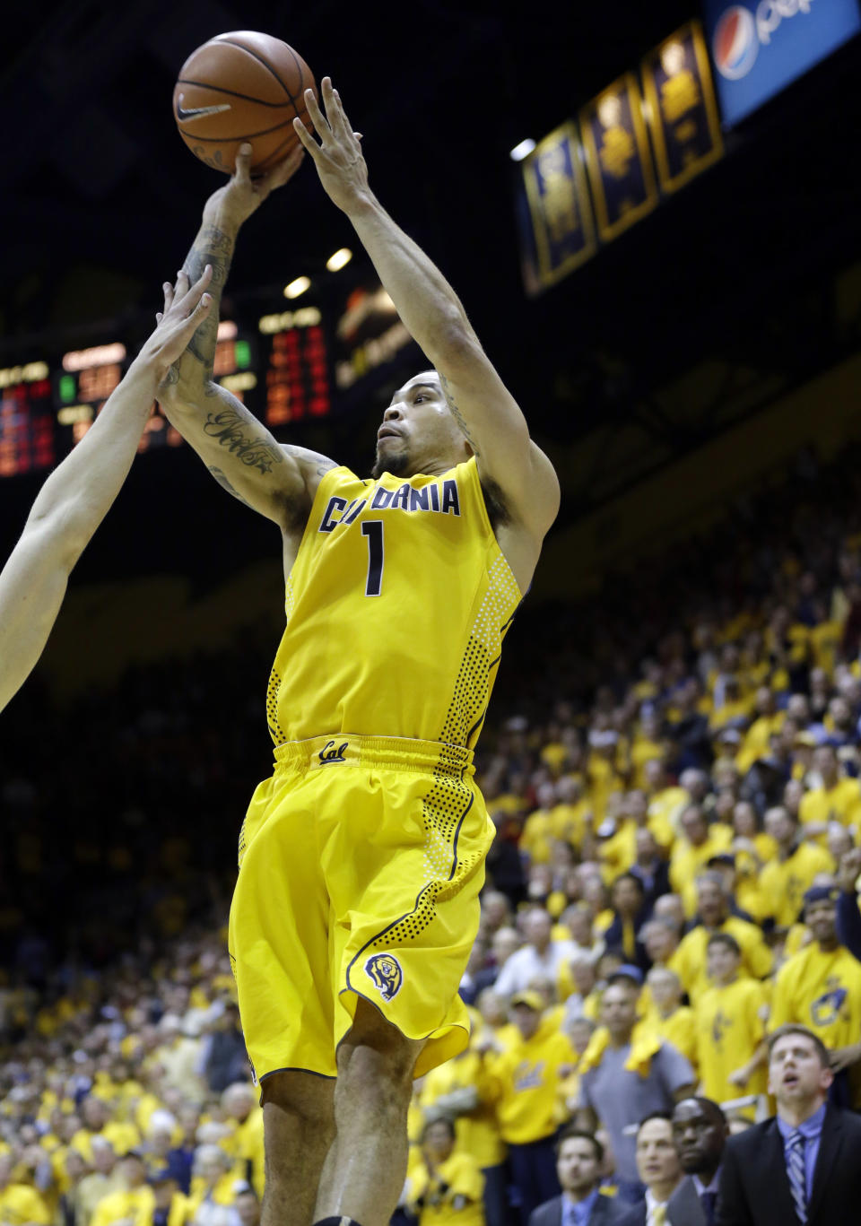 California guard Justin Cobbs (1) hits the game-winning shot in the closing seconds of the second half on an NCAA college basketball game on Saturday, Feb. 1, 2014, in Berkeley, Calif. California won 60-58. (AP Photo/Marcio Jose Sanchez)