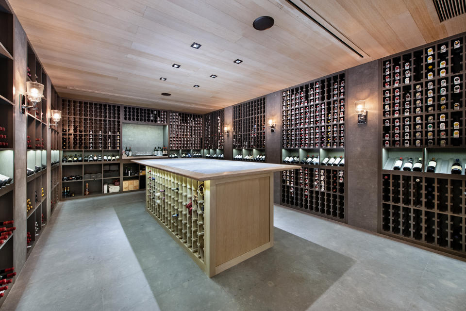 A 5,000-bottle wine cellar and an exotic fish tank add an opulent flair to the property. Photo by: Platinum Luxury Auctions.