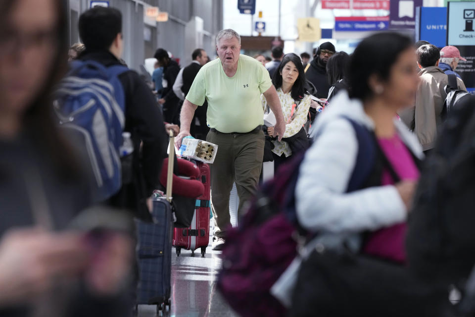 Travelers walk through Terminal 1 at O'Hare International Airport in Chicago, Monday, April 15, 2024. Pro-Palestinian demonstrators blocked a freeway leading to three Chicago O'Hare International Airport terminals Monday morning, temporarily stopping vehicle traffic into one of the nation's busiest airports and causing headaches for travelers. (AP Photo/Nam Y. Huh)