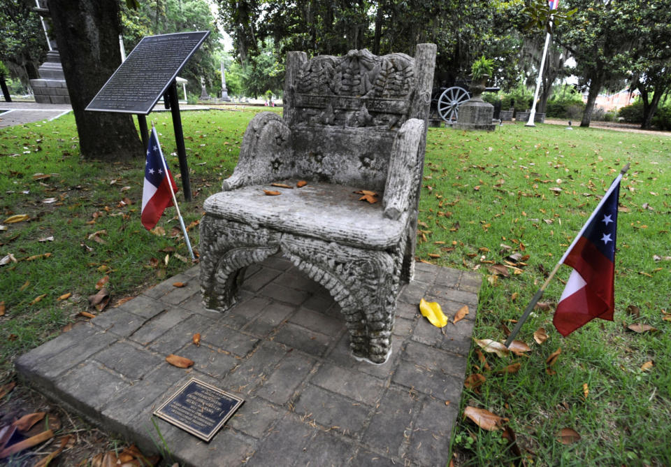 A monument to Confederate President Jefferson Davis, that was previously stolen, is shown back at its regular site at a cemetery in Selma, Ala., on Wednesday, June 2, 2021. Three people were charged following the disappearance of the chair, which was recovered in New Orleans and is now glued down. (AP Photo/Jay Reeves)