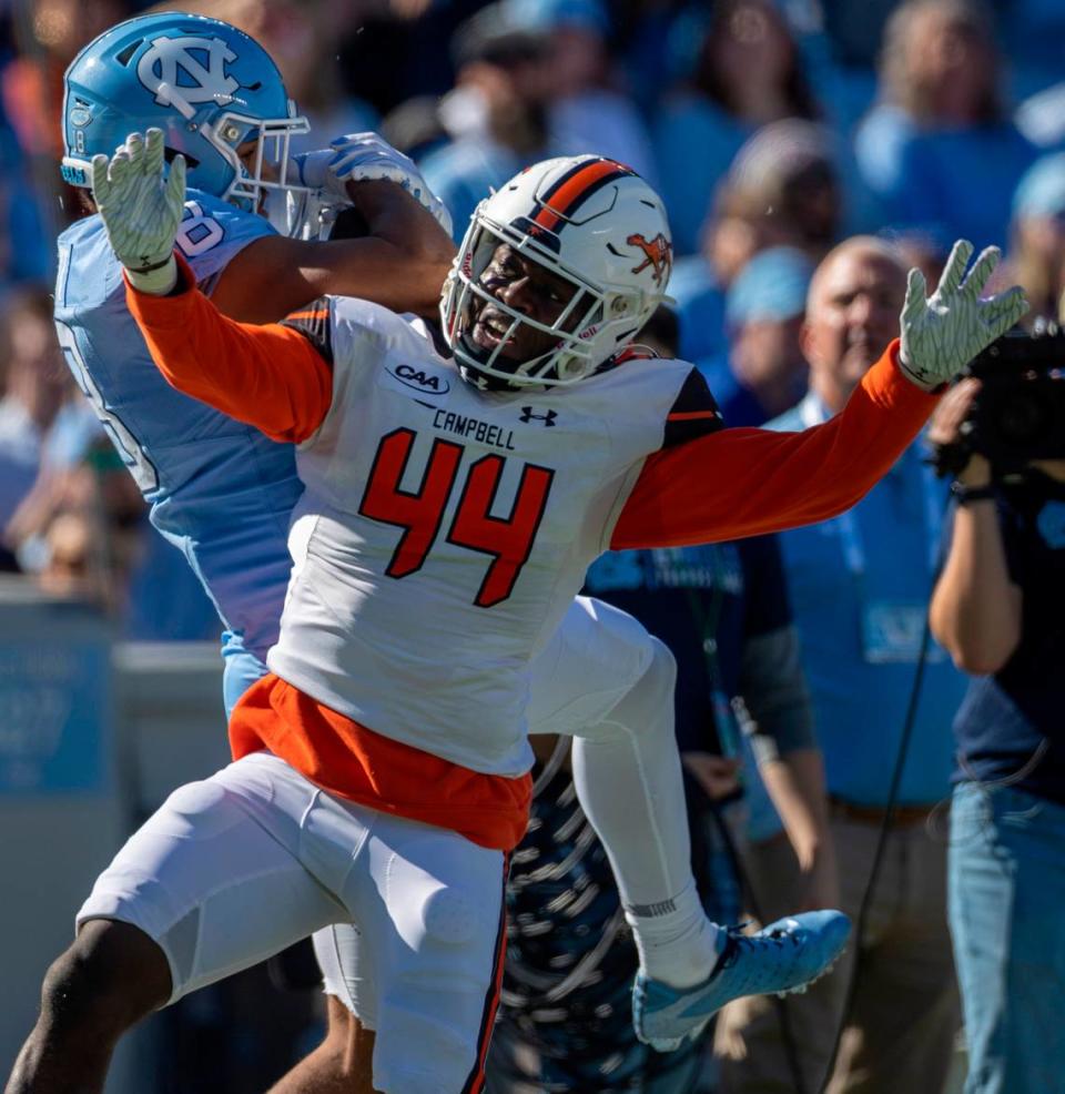 Campbell’s Ed Dennis (44) defends North Carolina’s Bryson Nesbitt (18) on a pass reception from quarterback Drake Maye in the first quarter on Saturday, November 4. 2023 at Kenan Stadium in Chapel Hill, N.C.