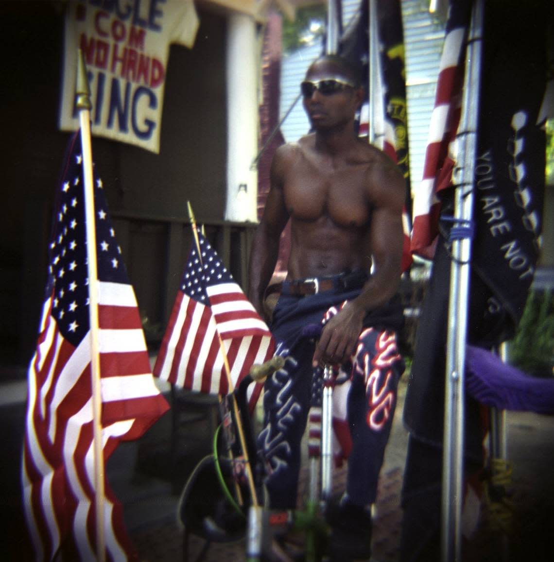 “I’m doing this in honor of the troops,” says the No Hand King, Rodney Hines, shown in this file photo with the American flag from all of his trick bikes in Raleigh. Staff Photo by Juli Leonard