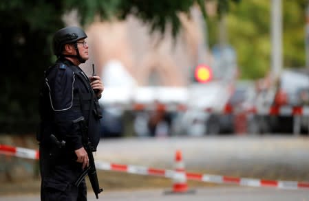 A police officer stands next to the site of a shooting in Halle