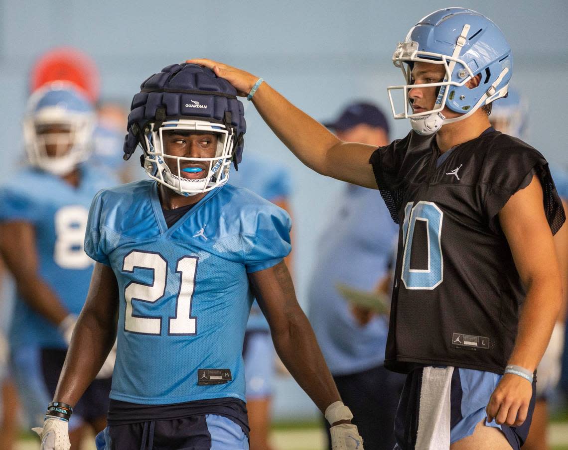 North Carolina quarterback Drake Maye (10) gives running back Elijah Green (21) a pat on the head during the Tar Heels’ first practice of the season on Wednesday, August 2, 2023 in Chapel Hill, N.C.
