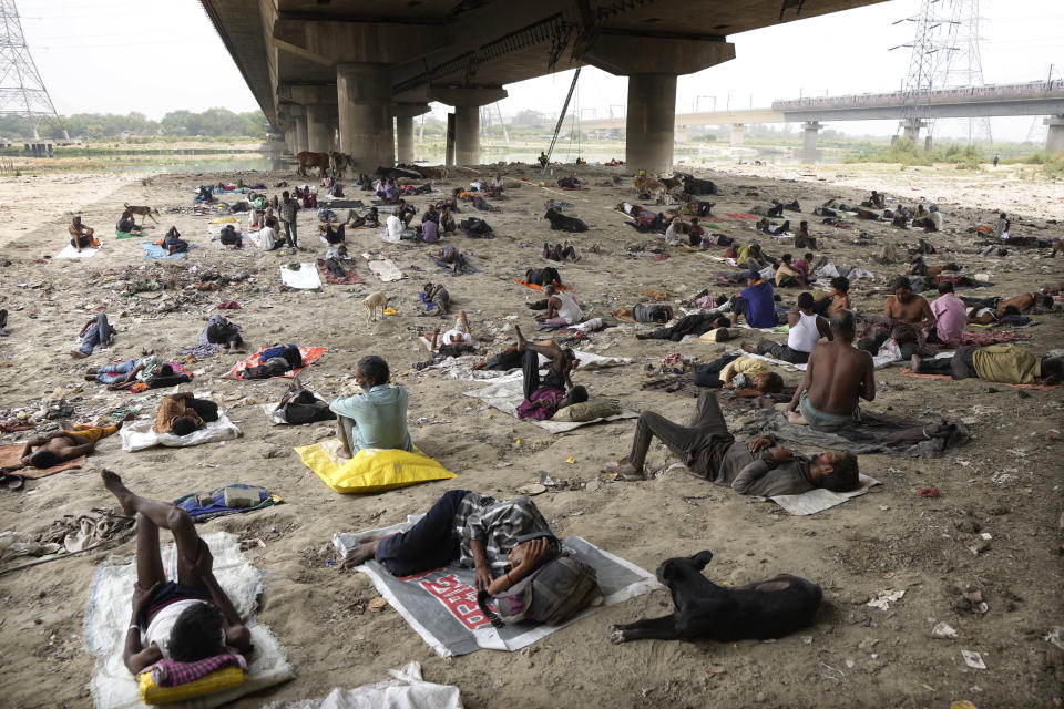 FILE - Homeless people sleep in the shade of an overpass to beat the heat wave in New Delhi, May 20, 2022. Indian authorities need more resources and better preparation to deal with searing heat particularly for the most vulnerable communities around the country, a New Delhi-based think tank said. (AP Photo/Manish Swarup, File)
