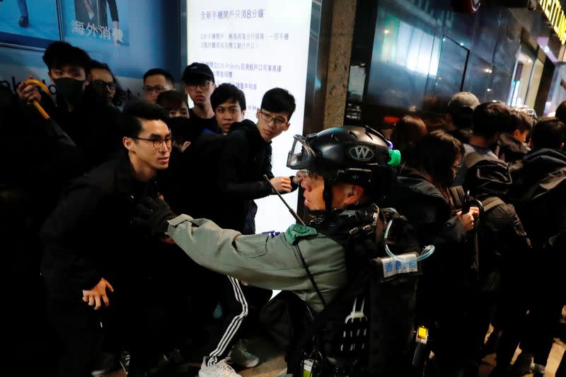 Riot police detain anti-government protesters in a large scale during a legal demonstration on the New Year's Day to call for better governance and democratic reforms in Hong Kong