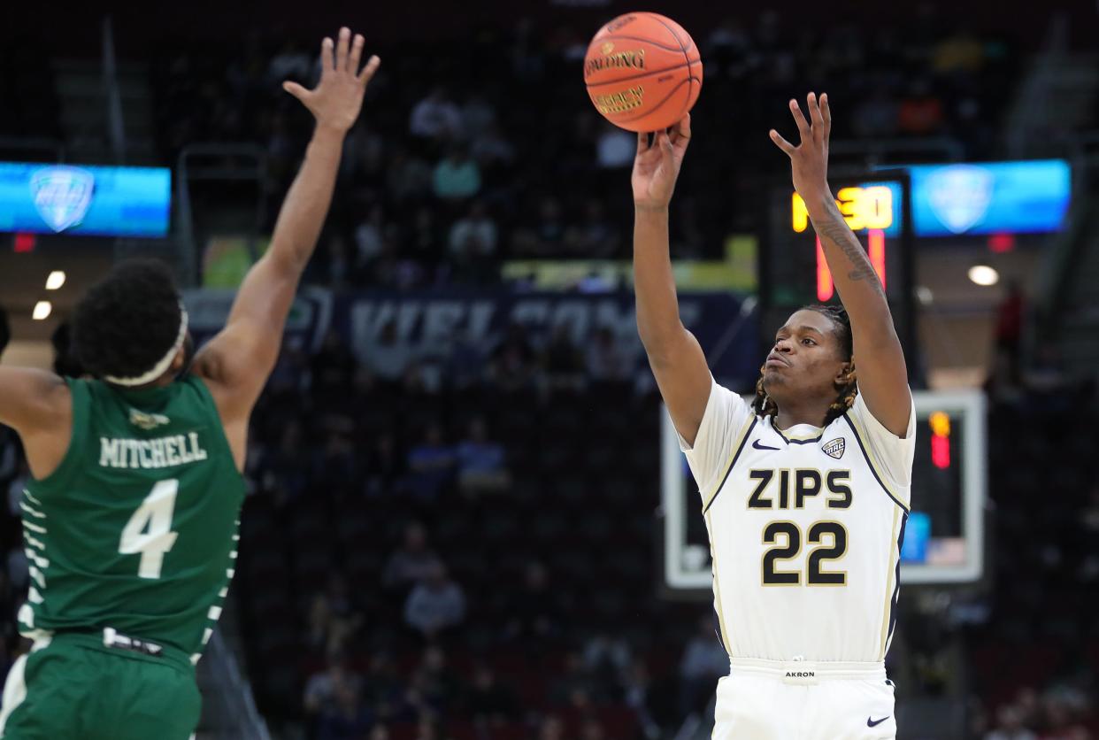 Akron Zips guard Mikal Dawson shoots over Ohio guard Shereef Mitchell during the second half of the Mid-American Conference Tournament semifinals, Friday, March 15, 2024, in Cleveland.