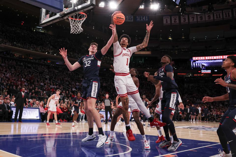 Nov 19, 2023; New York, New York, USA; Indiana Hoosiers center Kel'el Ware (1) rebounds against Connecticut Huskies center Donovan Clingan (32) and forward Samson Johnson (35) during the first half at Madison Square Garden.