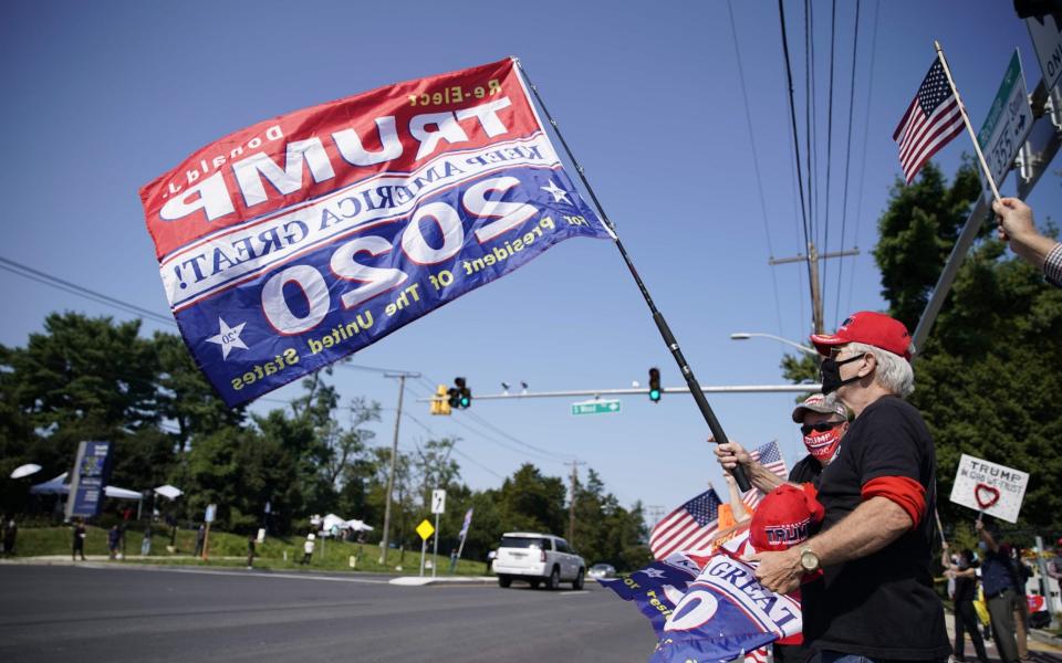 Supporters of US President Donald Trump hold signs and flags on October 4, 2020 outside of Walter Reed Medical Center in Bethesda, Maryland - Alex Edelman/AFP