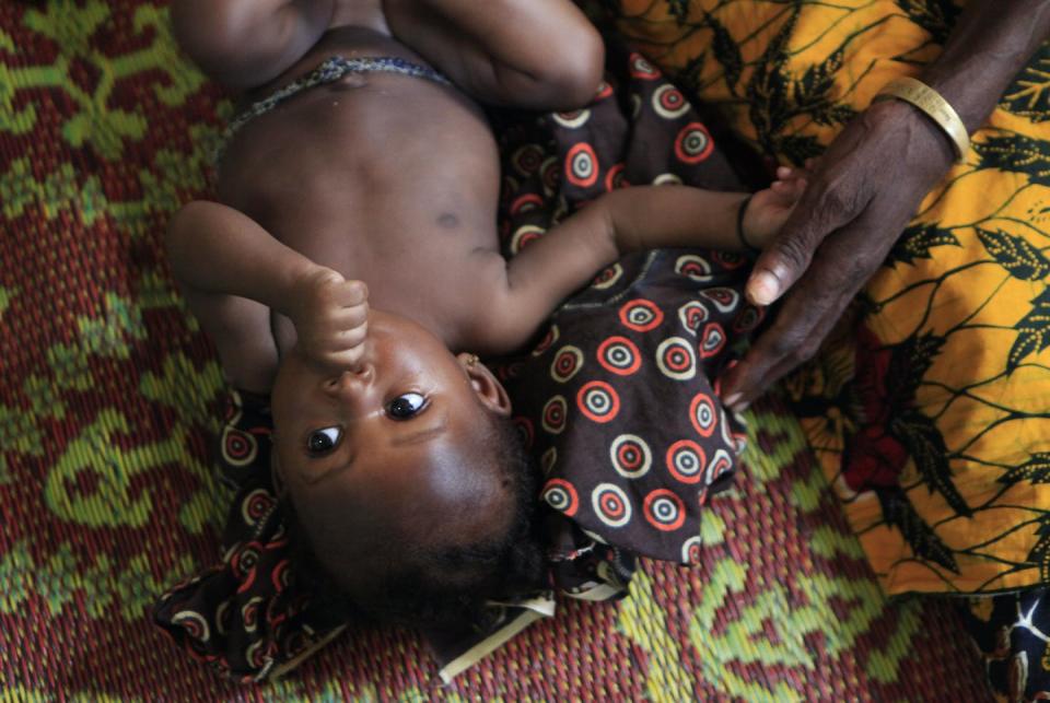 A 4-month-old baby girl is tended by her grandmother inside a church in Duekoue, Ivory Coast, in 2011. <a href="https://newsroom.ap.org/detail/IvoryCoast/db6beed455e1419cb9bf3e92533c8370/photo?Query=baby%20cote%20d%27ivoire&mediaType=photo&sortBy=arrivaldatetime:desc&dateRange=Anytime&totalCount=5&currentItemNo=0" rel="nofollow noopener" target="_blank" data-ylk="slk:AP Photo/Rebecca Blackwell;elm:context_link;itc:0;sec:content-canvas" class="link ">AP Photo/Rebecca Blackwell</a>