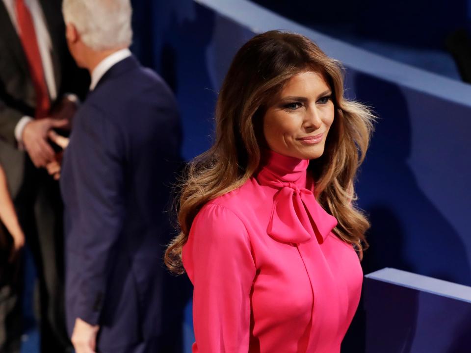 Melania Trump wears a bright pink blouse with a pussy-bow collar.