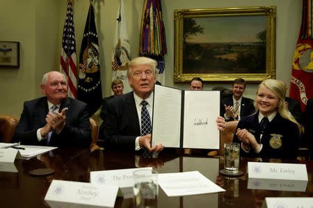 U.S. President Donald Trump shows a signed executive order during a roundtable discussion with farmers at the White House in Washington, U.S. April 25, 2017. REUTERS/Yuri Gripas