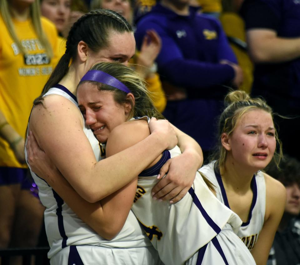 Avery Collins of Blissfield is hugged by teammate Julia White as she was taken out of the game along side Abrie Lauden as Hemlock beat the Royals 59-43 in the Division 3 state finals at the Breslin Center Michigan State University Saturday, March 18, 2023.