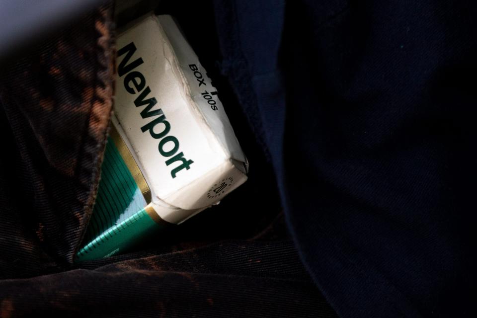 A Maysville, Kentucky man carries a pack of Newport menthol cigarettes in his pocket while sitting on a bench in Washington Park in Cincinnati, Ohio, on Wednesday, May 11, 2022.