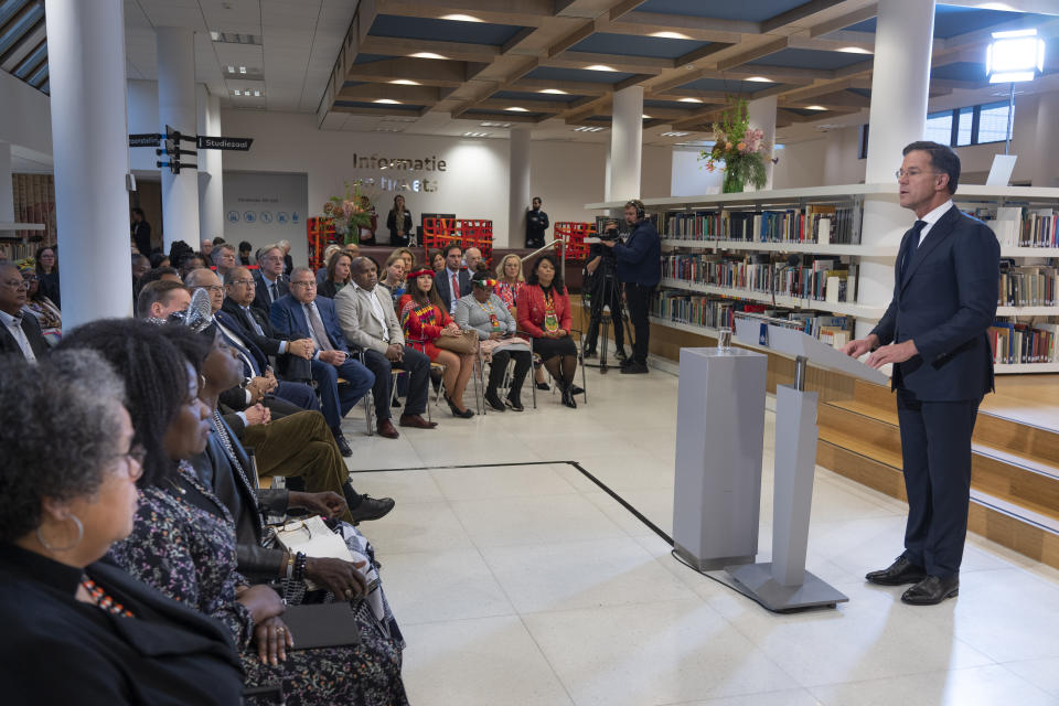 Dutch Prime Minister Mark Rutte, right, apologized on behalf of his government for the Netherlands' historical role in slavery and the slave trade at the National Archives in The Hague, Monday, Dec. 19, 2022. Rutte made the apology came despite some activist groups urging him to wait until next year to apologize on the July 1 anniversary of the country's abolition of slavery. (AP Photo/Peter Dejong)