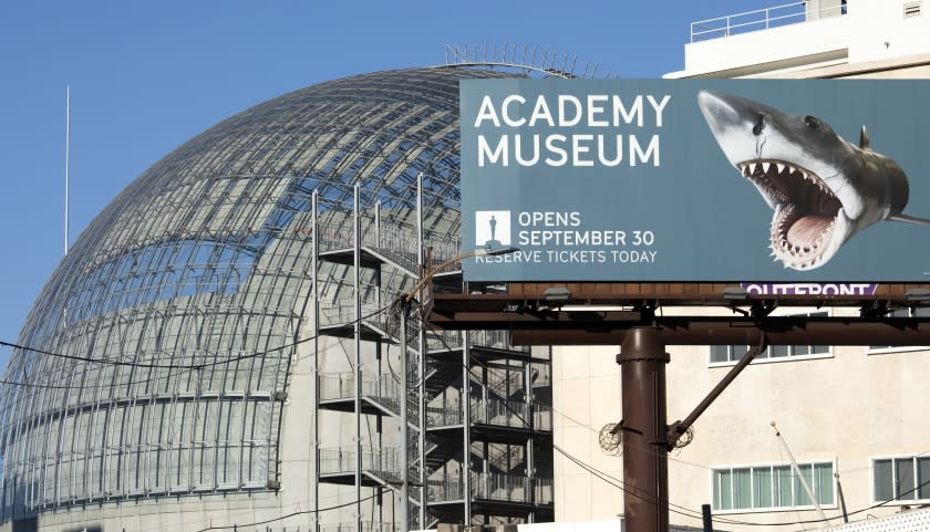 LOS ANGELES, CA - SEPTEMBER 13: A billboard announces the opening date of the Academy Museum of Motion Pictures. Renzo Piano brings new life to a storied May Co. building and creates a new icon for Los Angeles in the form of the Geffen Theater. Photographed at Academy Museum of Motion Pictures on Monday, Sept. 13, 2021 in Los Angeles, CA. (Myung J. Chun / Los Angeles Times)