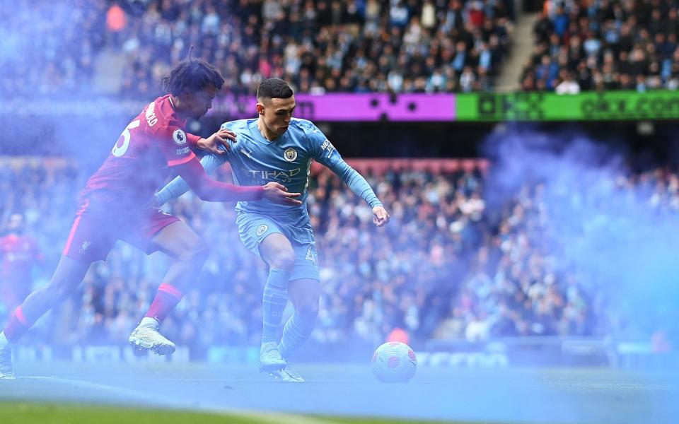 Trent Alexander-Arnold of Liverpool battles for possession with Phil Foden