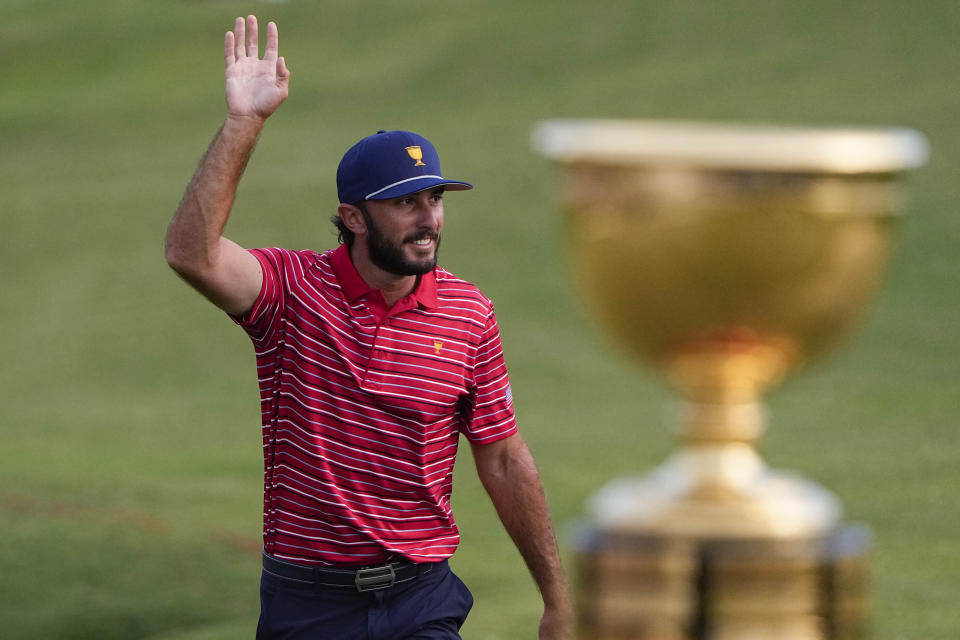 Max Homa walks to the 15th green after the USA team won the singles match at the Presidents Cup golf tournament at the Quail Hollow Club, Sunday, Sept. 25, 2022, in Charlotte, N.C. (AP Photo/Chris Carlson)