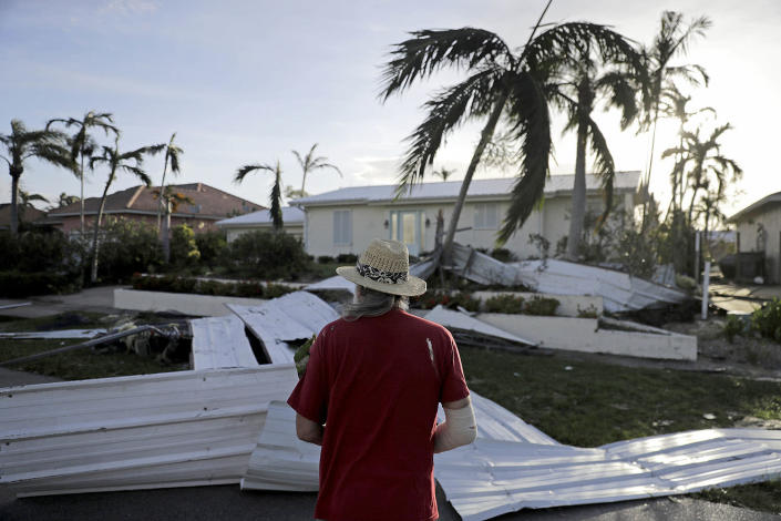 <p><strong>Marco Island</strong><br>A roof is strewn across a home’s lawn as Rick Freedman checks his neighbor’s damage from Hurricane Irma in Marco Island, Fla., Sept. 11, 2017. (Photo: David Goldman/AP) </p>