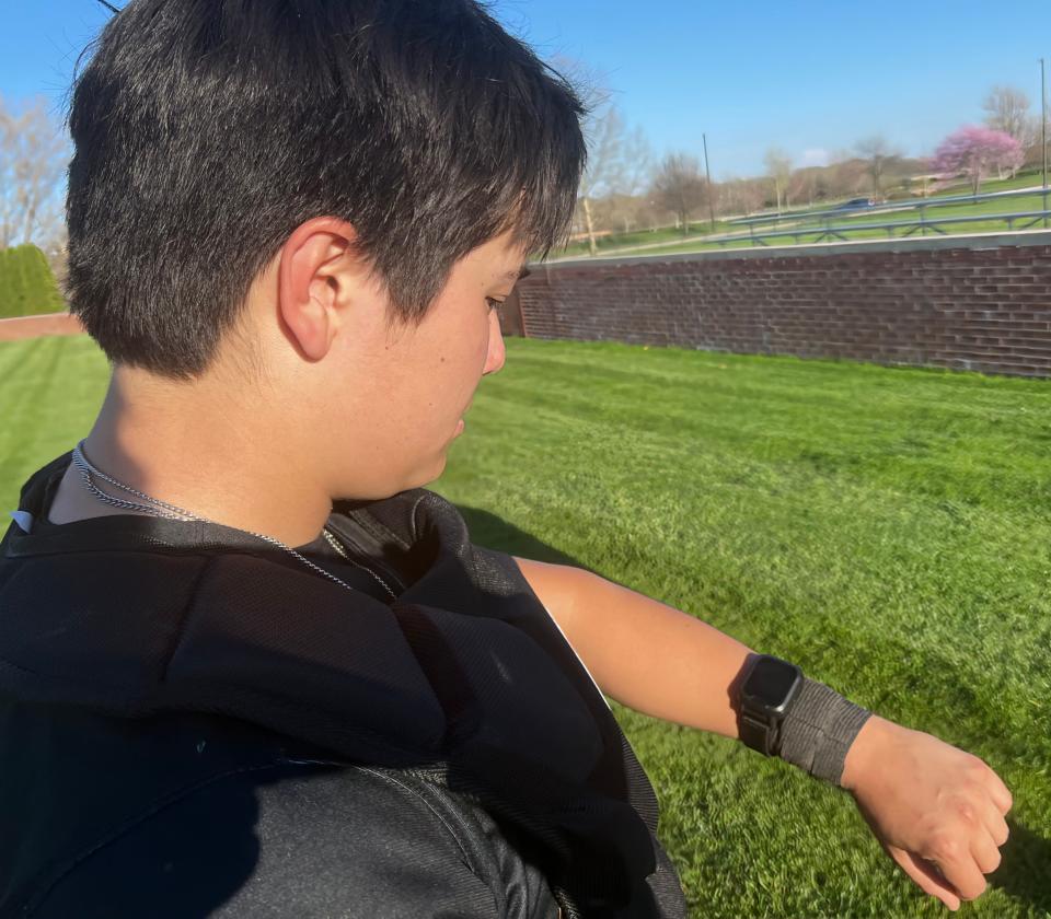 Upper Arlington catcher Mark Lee displays the GoRout communication system the team is utilizing this season to send pitch instructions from coach to catcher.