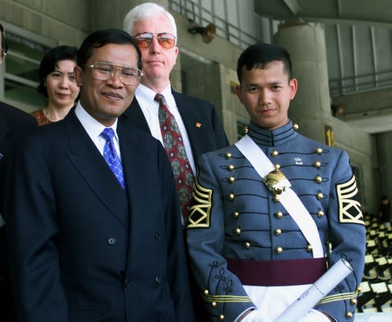 Cambodia's Prime Minister Hun Sen, left, stands with his son Hun Manet after graduation ceremonies at the United States Military Academy at West Point, May 29, 1999. <span class="copyright">Jeff Christensen—Reuters</span>