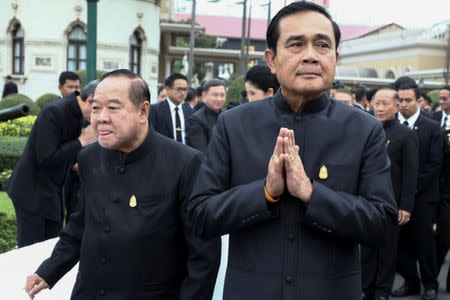 Thailand's Prime Minister Prayuth Chan-ocha (R) and Deputy Prime Minister and Defence Minister Prawit Wongsuwan greet government officers before a weekly cabinet meeting at Government House in Bangkok, Thailand, January 4, 2017. REUTERS/Athit Perawongmetha