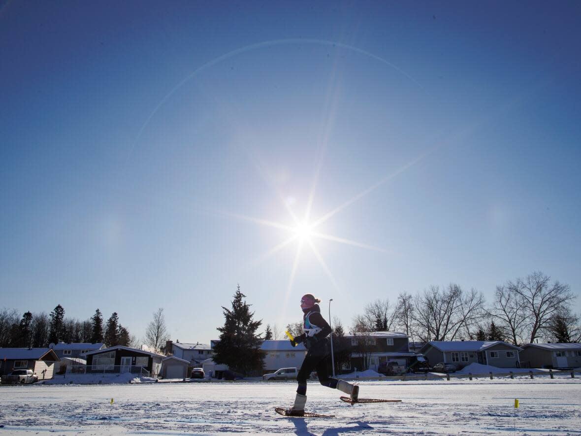 A snowshoe racer competes on Day 4 of the 2023 Arctic Winter Games, in Fort McMurray, Alta. (Evan Mitsui/CBC - image credit)