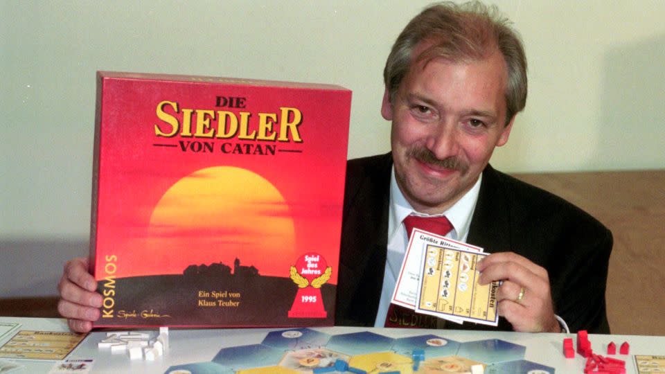 Klaus Teuber, a dental technician from Darmstadt, presents his game, "The Settlers of Catan," on September 29, 1995, in Frankfurt, Germany. - Bernd Kammerer/AP