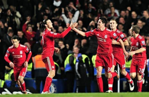 Liverpool's English defender Martin Kelly (R) celebrates scoring the second goal with English striker Andy Carroll (L) during their League Cup football match against Chelsea at Stamford Bridge, London. Liverpool won 2-0