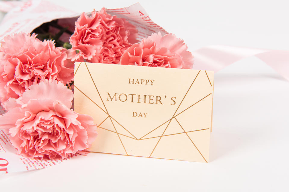 Pink carnations flower and card on white background.Happy Mother‘s day