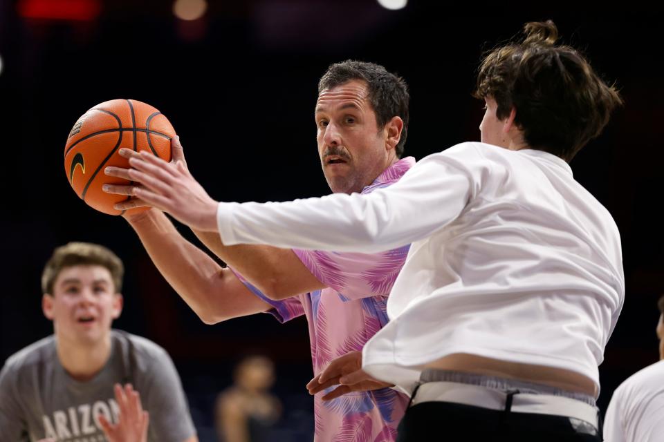 Actor Adam Sandler plays a pickup game with Arizona Wildcats managers prior to the game against the Colorado Buffaloes at McKale Center on Jan. 4, 2024, in Tucson.