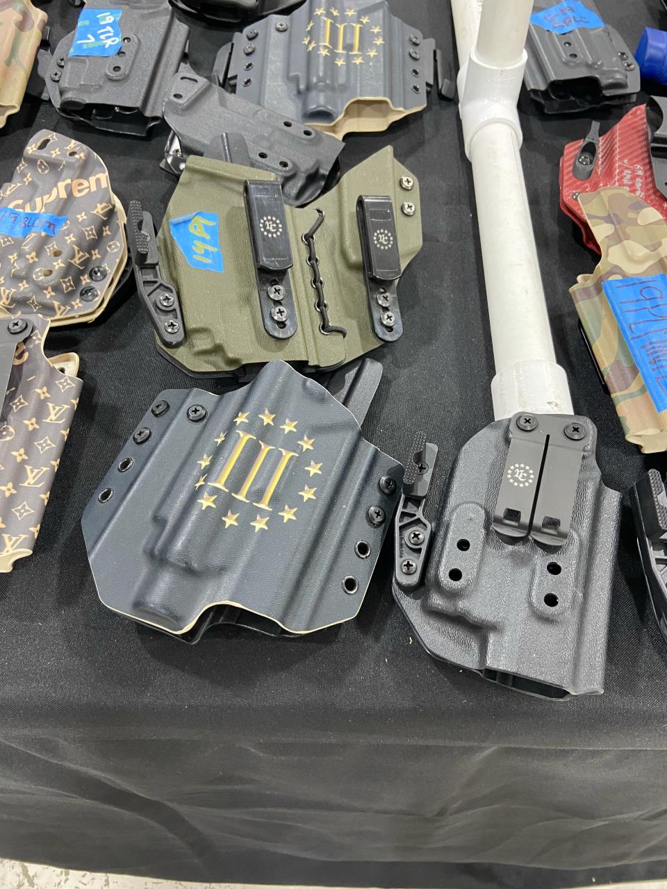 Hardware on sale at the Atlanta Gun Show display the logo of the extremist Three Percenters militia group.