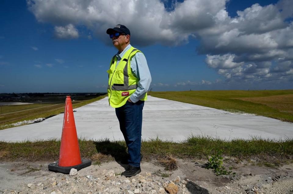 Site operators at Piney Point recently announced a milestone achievement with the closure of the Old Gypsum Stack-South compartment, one of four ponds that need to be closed at the former phosphate processing plant. The white pad to the left of Herb Donica is a weir, a ramp that prevents water from remaining in the pond. In the event of heavy rain, the pond is designed to overflow past the weir and into a stormwater collection area.