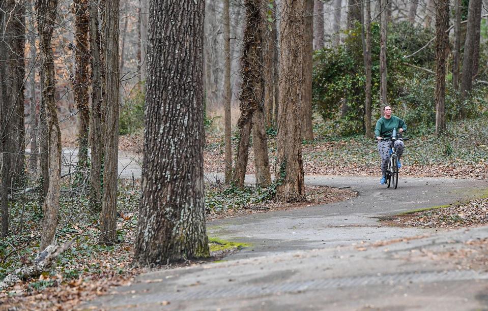 Laurabeth Mitchell of Spartanburg, S.C. rides along the Daniel Morgan Trail system at Duncan Park in Spartanburg Tuesday, January 31, 2023.  Thirteen recreation projects in South Carolina were the recipients of federal Land and Water Conservation Fund (LWCF) grants, including a $300,000 grant toward a $600,000 project to connect the Mary Black Foundation Rail Trail and Daniel Morgan Trail system, replace a wooden bridge with an aluminum one, and remove an invasive plant species in the park. 