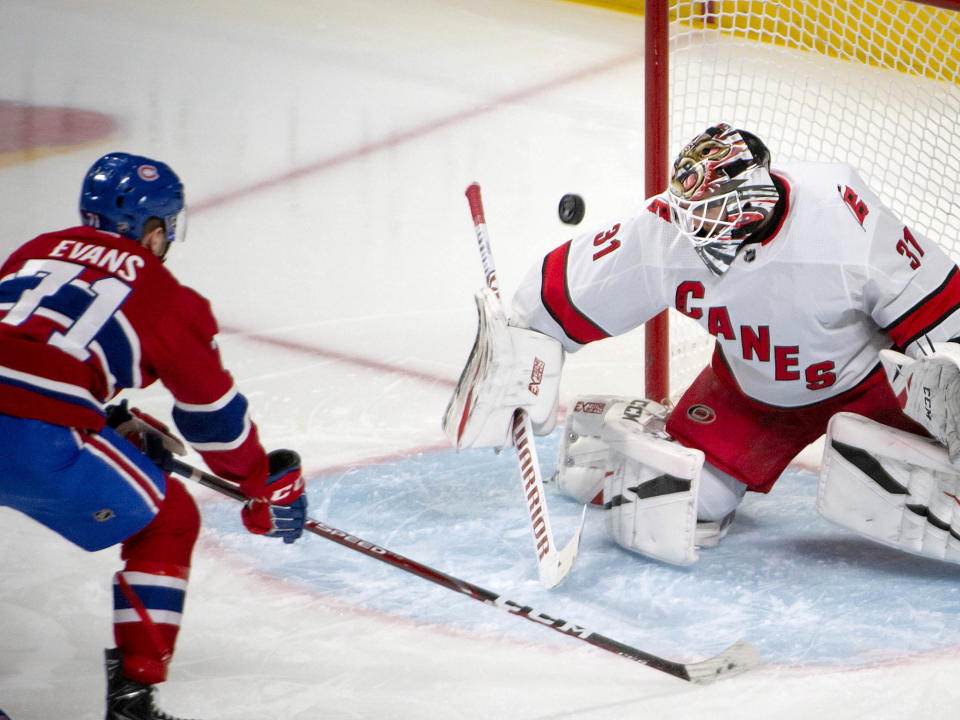 Carolina Hurricanes goaltender Anton Forsberg (31) makes a save as Montreal Canadiens center Jake Evans (71) looks for a rebound during the second period of an NHL hockey game Saturday, Feb. 29, 2020, in Montreal. (Peter McCabe/The Canadian Press via AP)