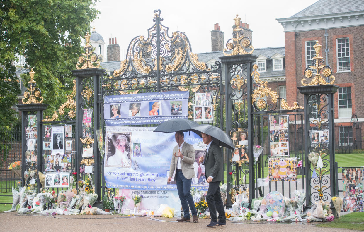 LONDON, ENGLAND - AUGUST 30:  Prince William, Duke of Cambridge and Prince Harry look upon flowers, photos and other souvenirs left as a tribute to Princess Diana near The Sunken Garden at Kensington Palace on August 30, 2017 in London, England.  (Photo by Samir Hussein/Samir Hussein/WireImage)