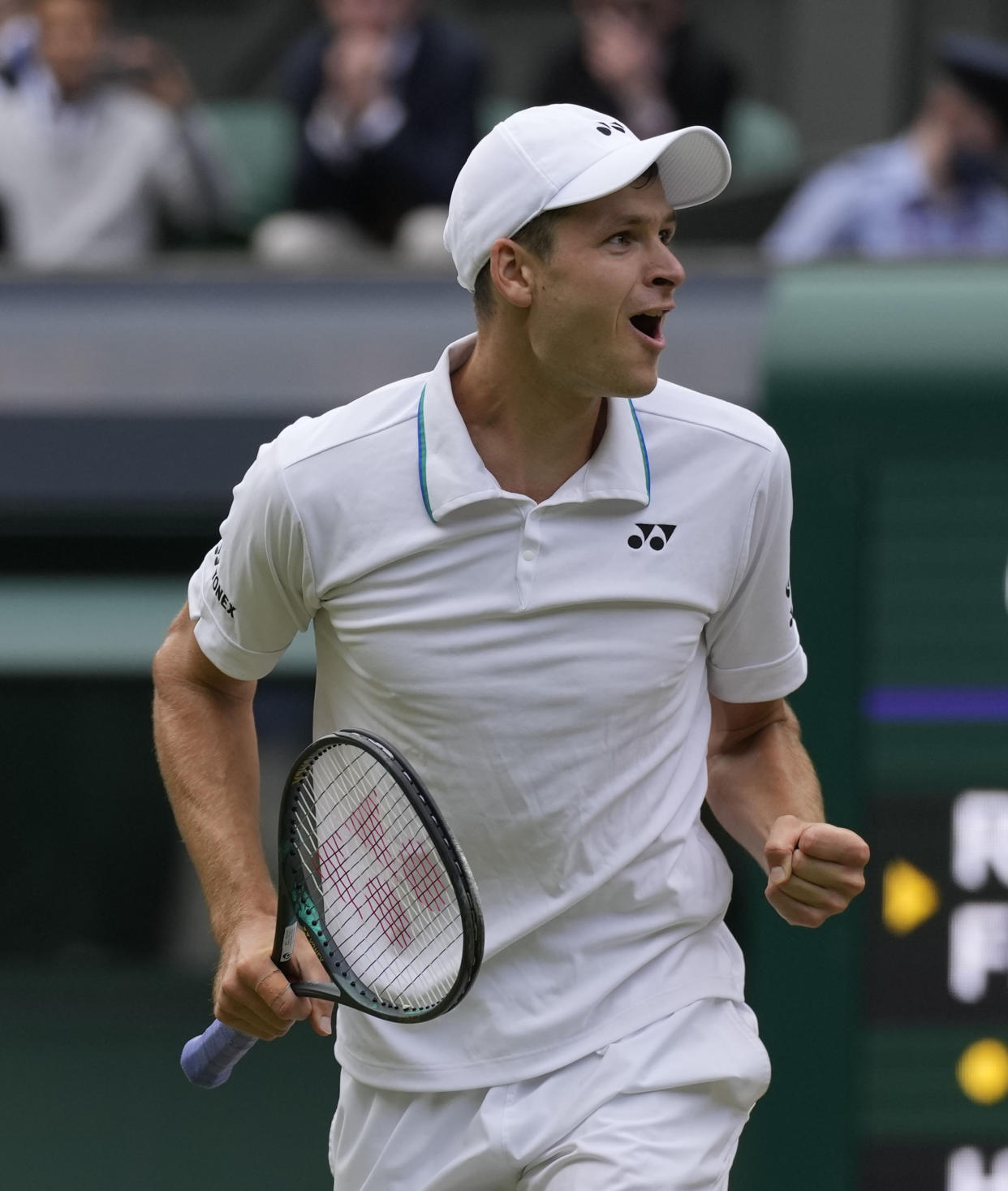 Poland's Hubert Hurkacz celebrates after defeating Switzerland's Roger Federer during the men's singles quarterfinals match on day nine of the Wimbledon Tennis Championships in London, Wednesday, July 7, 2021. (AP Photo/Kirsty Wigglesworth)