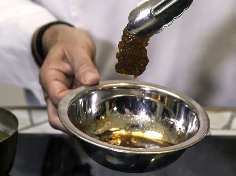 A chef prepares a lab-grown steak during a presentation in Jaffa, January 2019