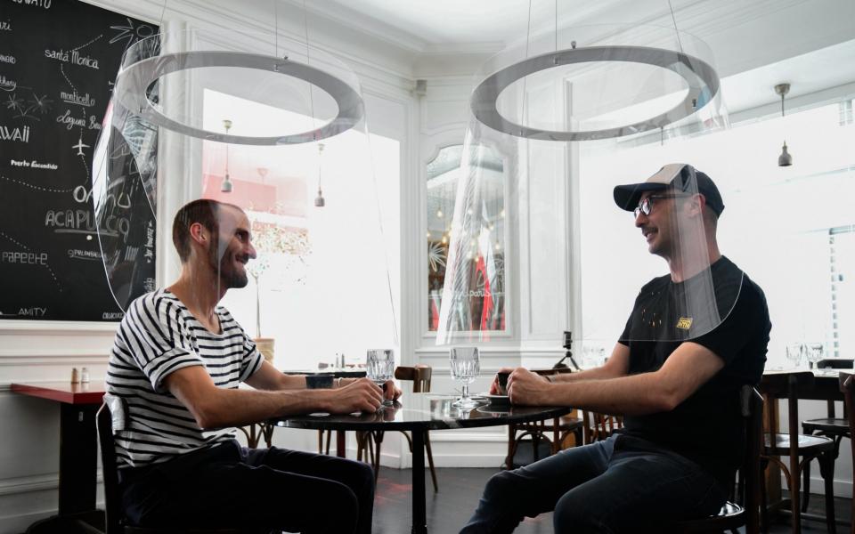 French designer Christophe Gernigon's plexiglass protection design "Plex'Eat" in a cafe in Paris - Getty