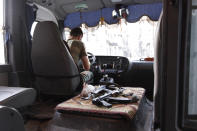 A rabbit is pictured next to weapons in a Free Syrian Army bus in Bustan Al-Basha district in Aleppo September 18, 2012. REUTERS/Zain Karam (SYRIA - Tags: CONFLICT CIVIL UNREST POLITICS ANIMALS)