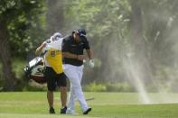 Apr 21, 2019; Hilton Head, SC, USA; Shane Lowry and his caddie are caught in a small sand vortex on the fairway of the fifth hole during the final round of the RBC Heritage golf tournament at Harbour Town Golf Links. Mandatory Credit: Joshua S. Kelly-USA TODAY Sports